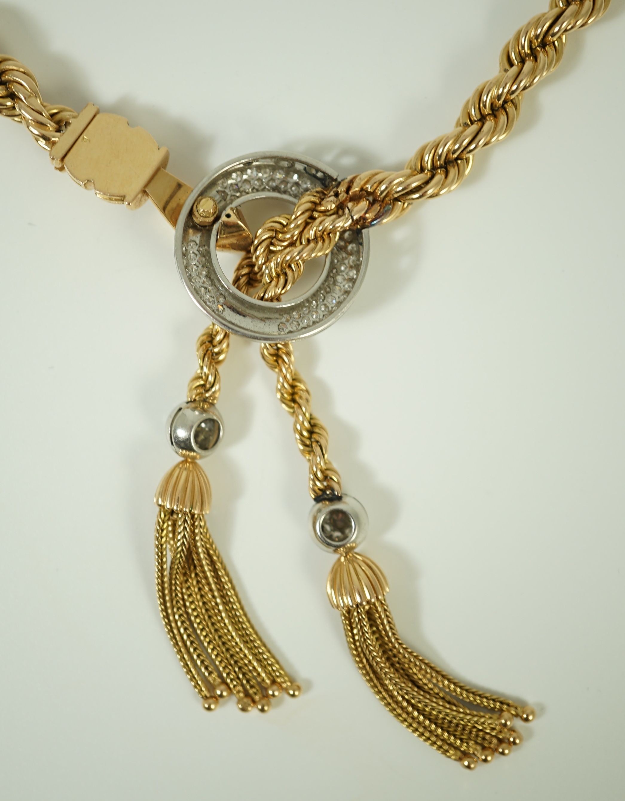 A modern heavy Middle Eastern gold and diamond set rope twist drop tassel necklace, together with a similar gold and diamond set bracelet